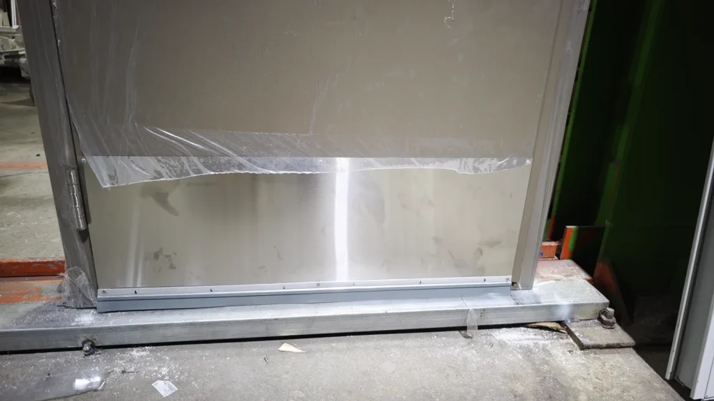Close view of hospital door kick plate and bottom edge