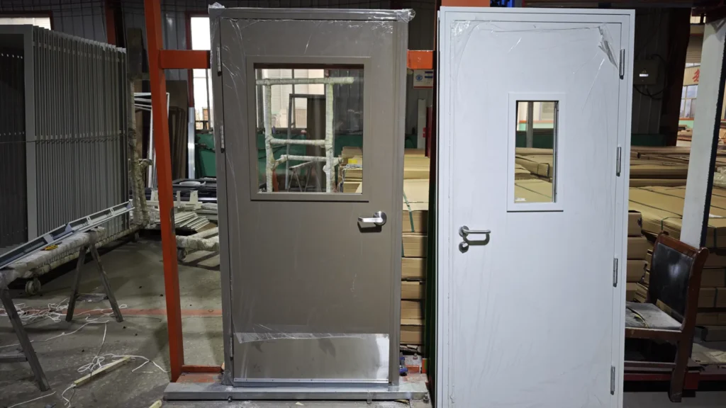 Two finished commercial door sets on the production floor