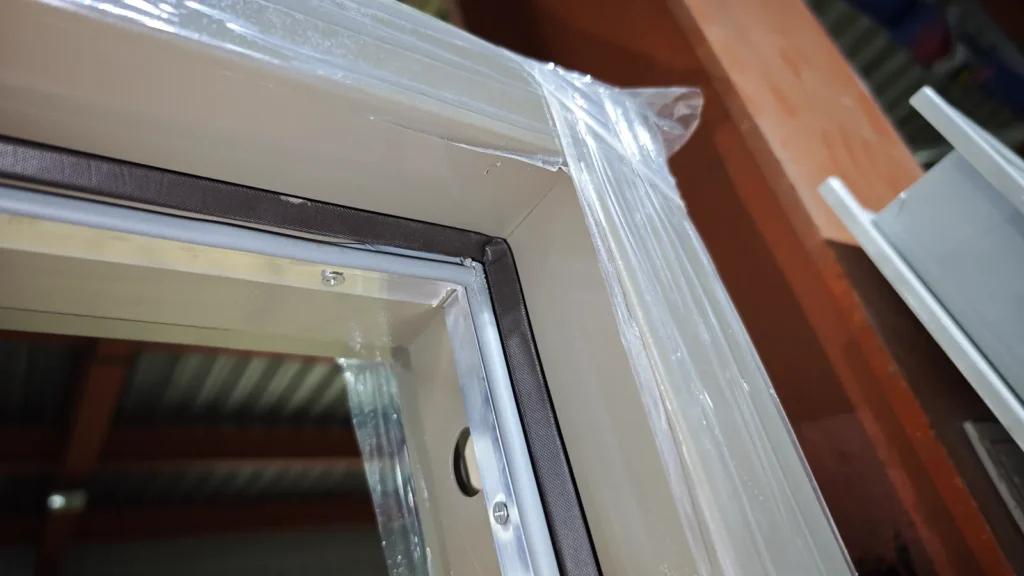 Close view of the vision panel frame and gasket on a hospital door