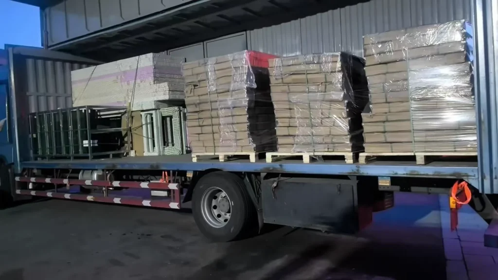 Palletized door and frame components wrapped and secured on a delivery truck