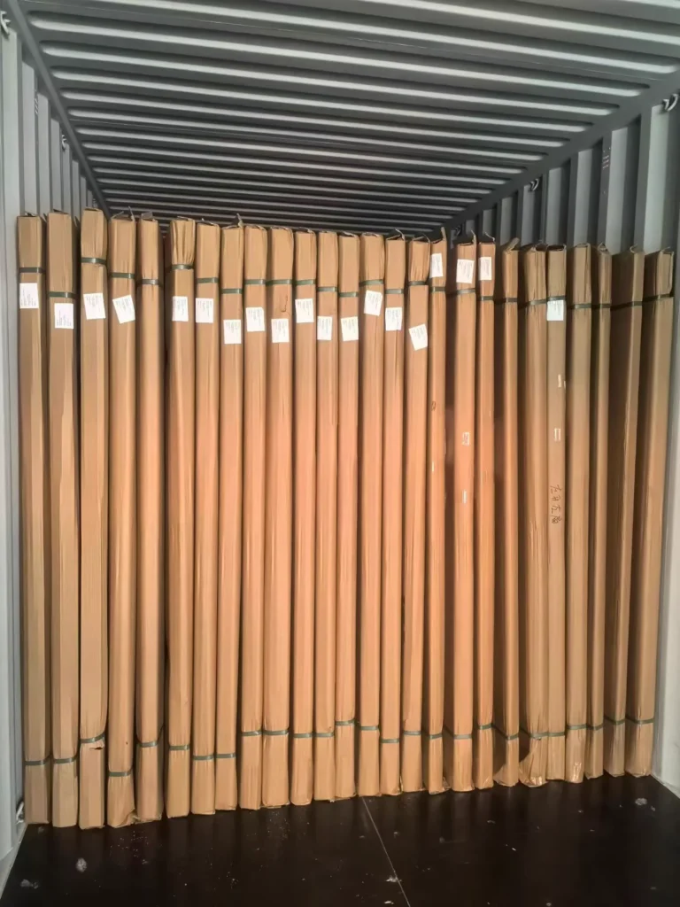 Wrapped door leaves secured with straps inside an export shipping container