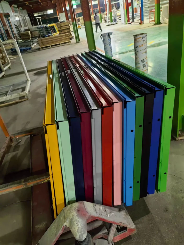 Custom colour steel door components arranged on the factory production floor