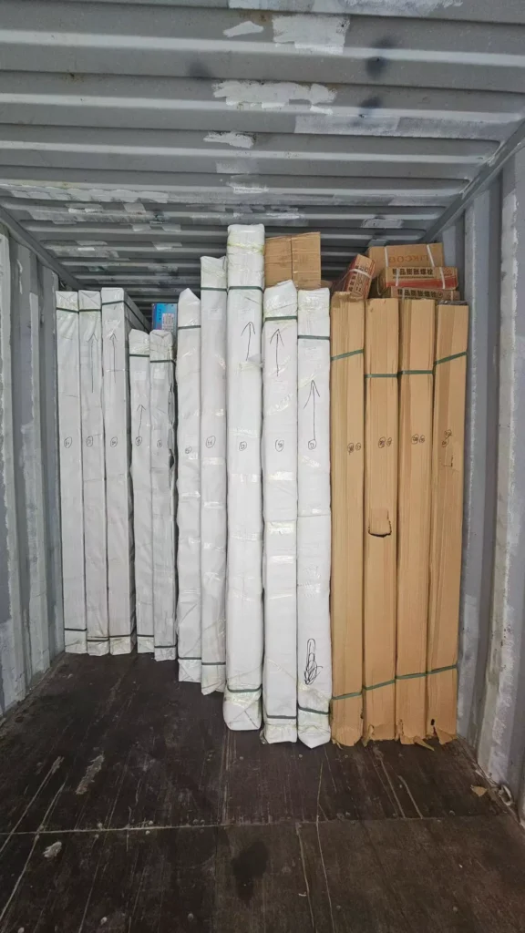 Protected door packages loaded upright inside an export container