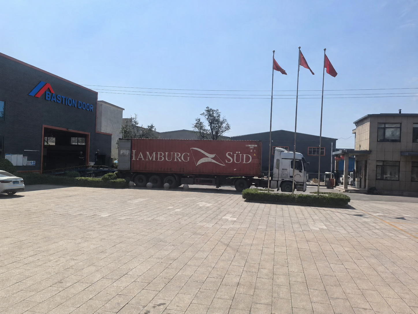 Bastion factory with export container collecting UL-certified fire doors for shipment to Canada